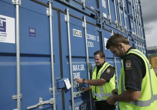 Customs officers inspecting containers